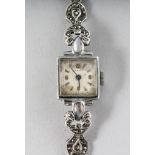 AN EDWARDIAN SILVER AND MARCASITE COCKTAIL WATCH.