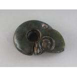 A CARVED JADE AMULET, a "head". 2.25ins.