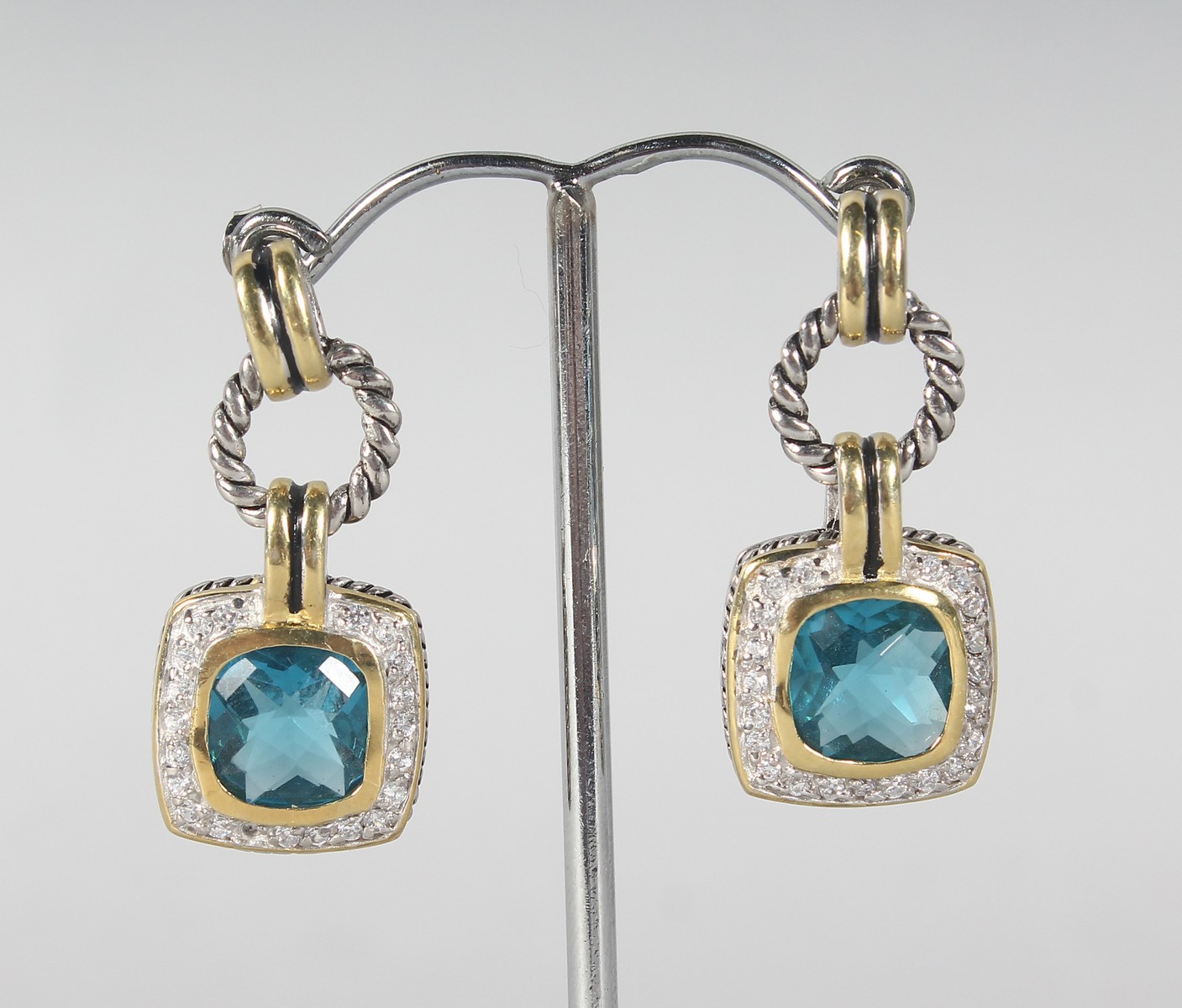 A PAIR OF SILVER AND BLUE TOPAZ EARRINGS.