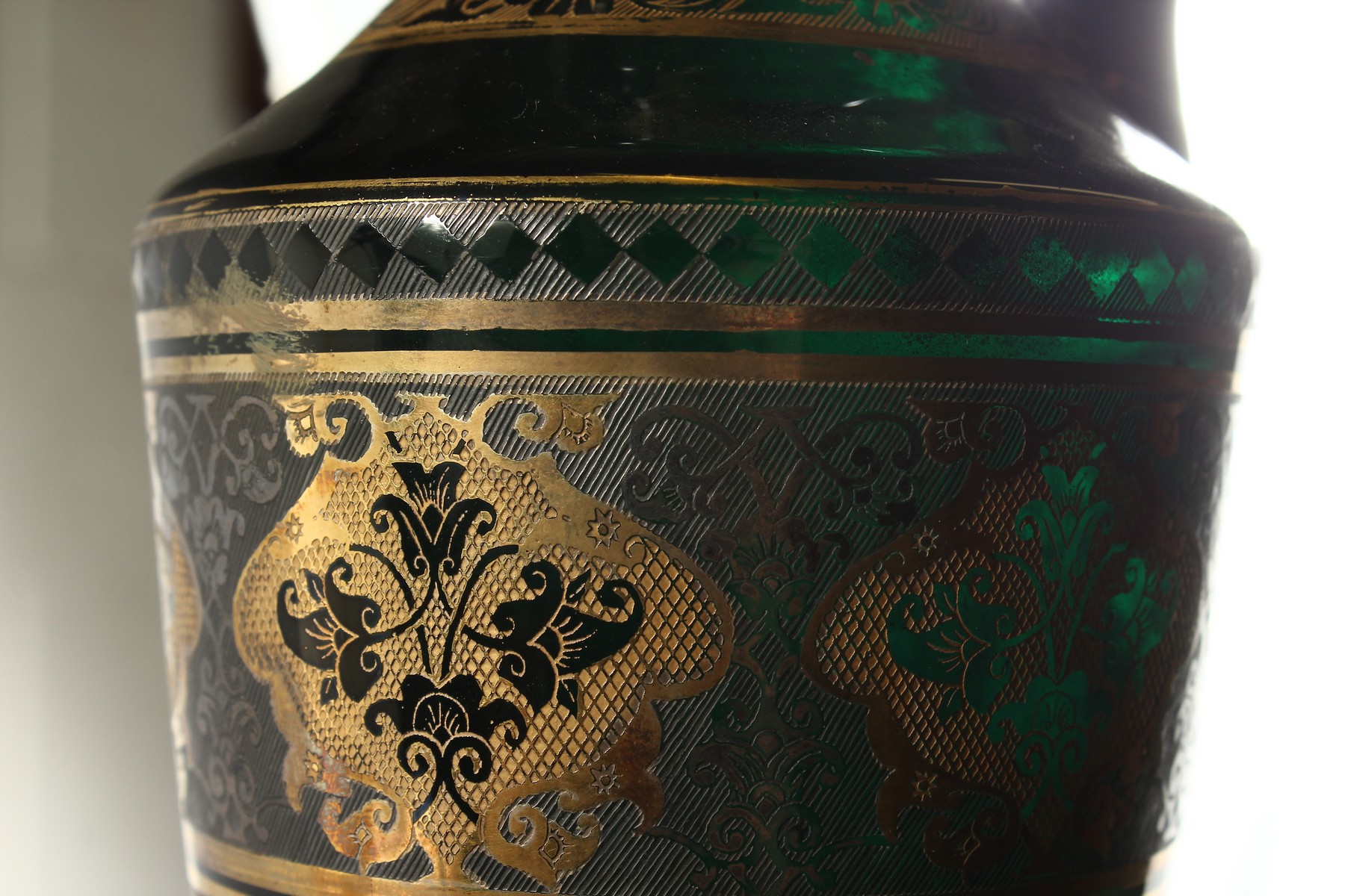 A CONTINENTAL DARK GREEN GLASS EWER AND STOPPER, with etched and gilded decoration. 14ins high. - Image 9 of 11