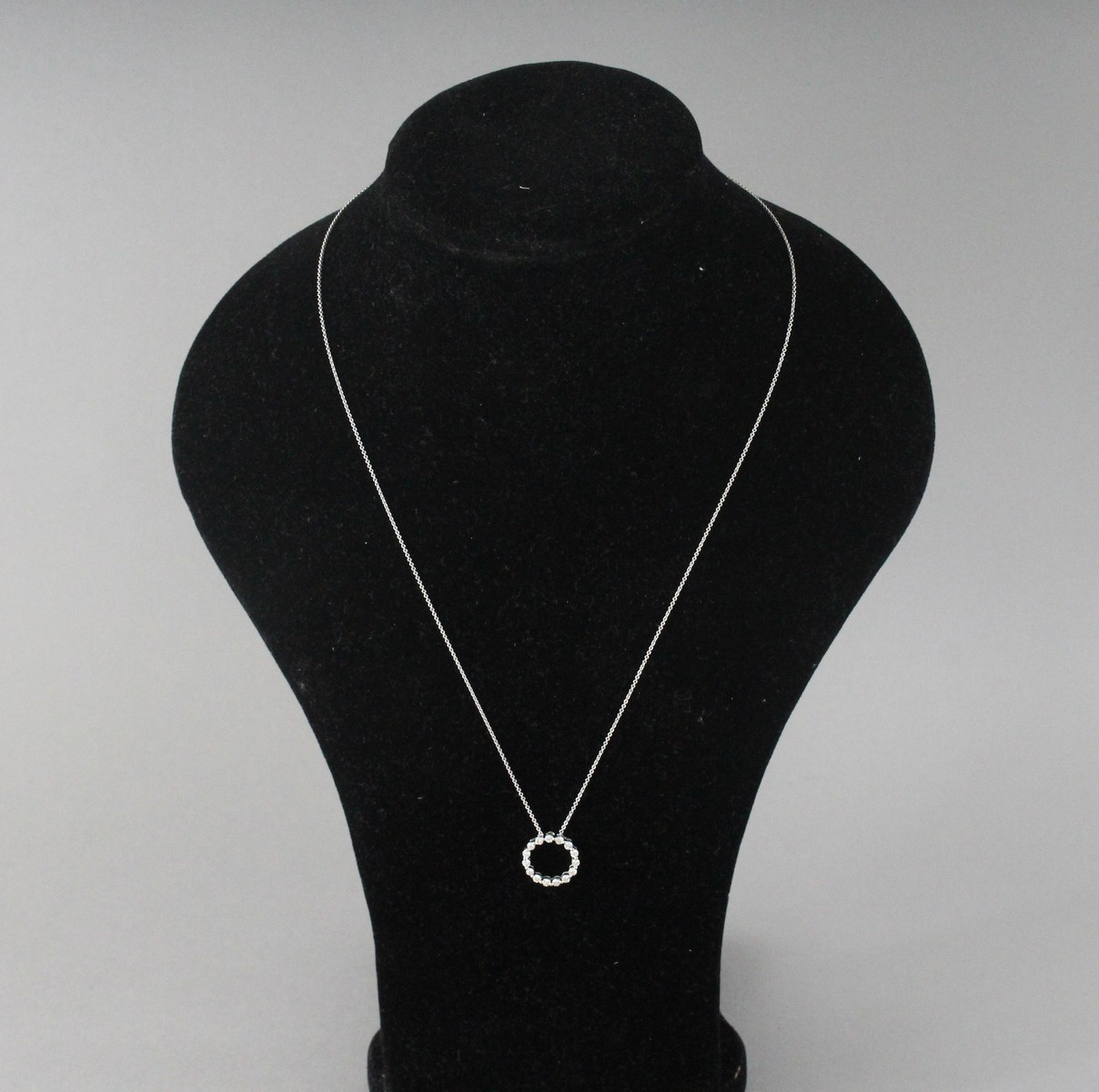 AN 18CT WHITE GOLD CHAIN WITH DIAMOND RING.