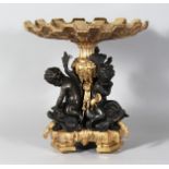 A GOOD BRONZE AND GILT BRONZE COMPORT with three cupids and dolphin support. 13ins high.