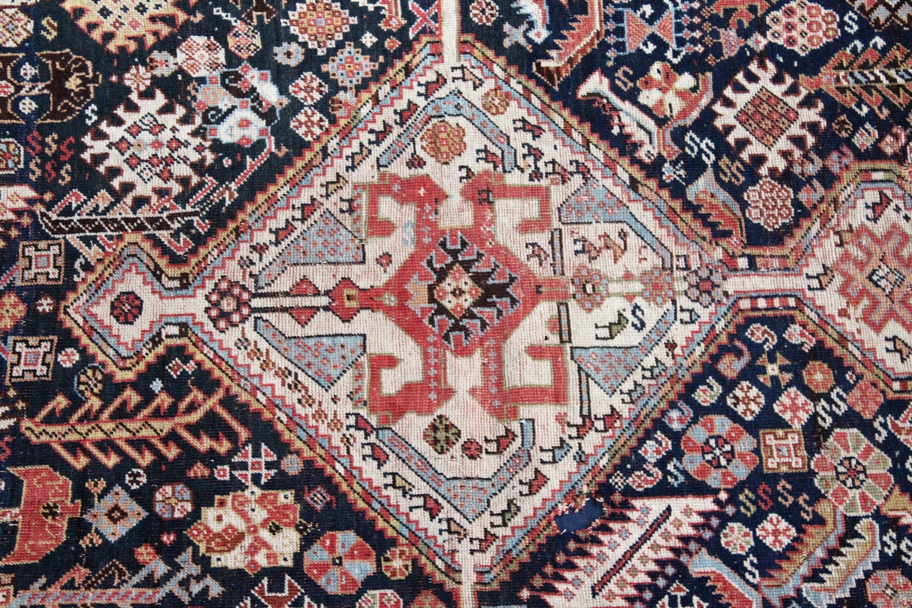 A PERSIAN QASHQAI RUG, early 20th century, dark blue ground with a central diamond shaped panel. 7ft - Image 2 of 6