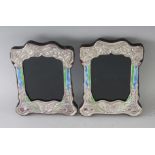 A PAIR OF NOUVEAU SILVER AND ENAMEL BUTTERFLY PHOTOGRAPH FRAMES. 8ins x 6.5ins.