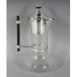 A CHRISTOPHER DRESSER DESIGN PLAIN GLASS CLARET JUG with plated mounts. 11ins high.