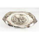 A WMF ART NOUVEAU PEWTER DISH, the centre embossed with playful cherubs, the handles cast as