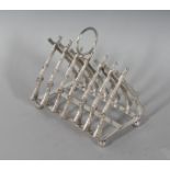 A SIX-DIVISION CROSSED RIFLES TOAST RACK. 4ins long.