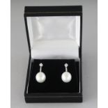 A GOOD PAIR OF PEARL AND DIAMOND DROP EARRINGS.