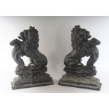 A PAIR OF CAST IRON RAMPANT LION DOOR STOPS. 14ins high.