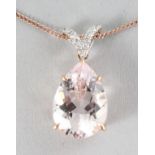 AN 18CT ROSE GOLD PEAR SHAPED MORGANITE (4.92cts) AND DIAMOND (0.07cts) PENDANT on a chain.