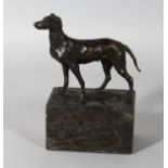 A BRONZE DOG on a marble plinth. 7.5ins overall.