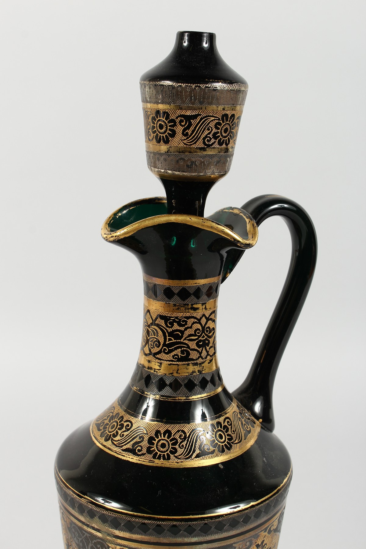 A CONTINENTAL DARK GREEN GLASS EWER AND STOPPER, with etched and gilded decoration. 14ins high. - Image 3 of 11