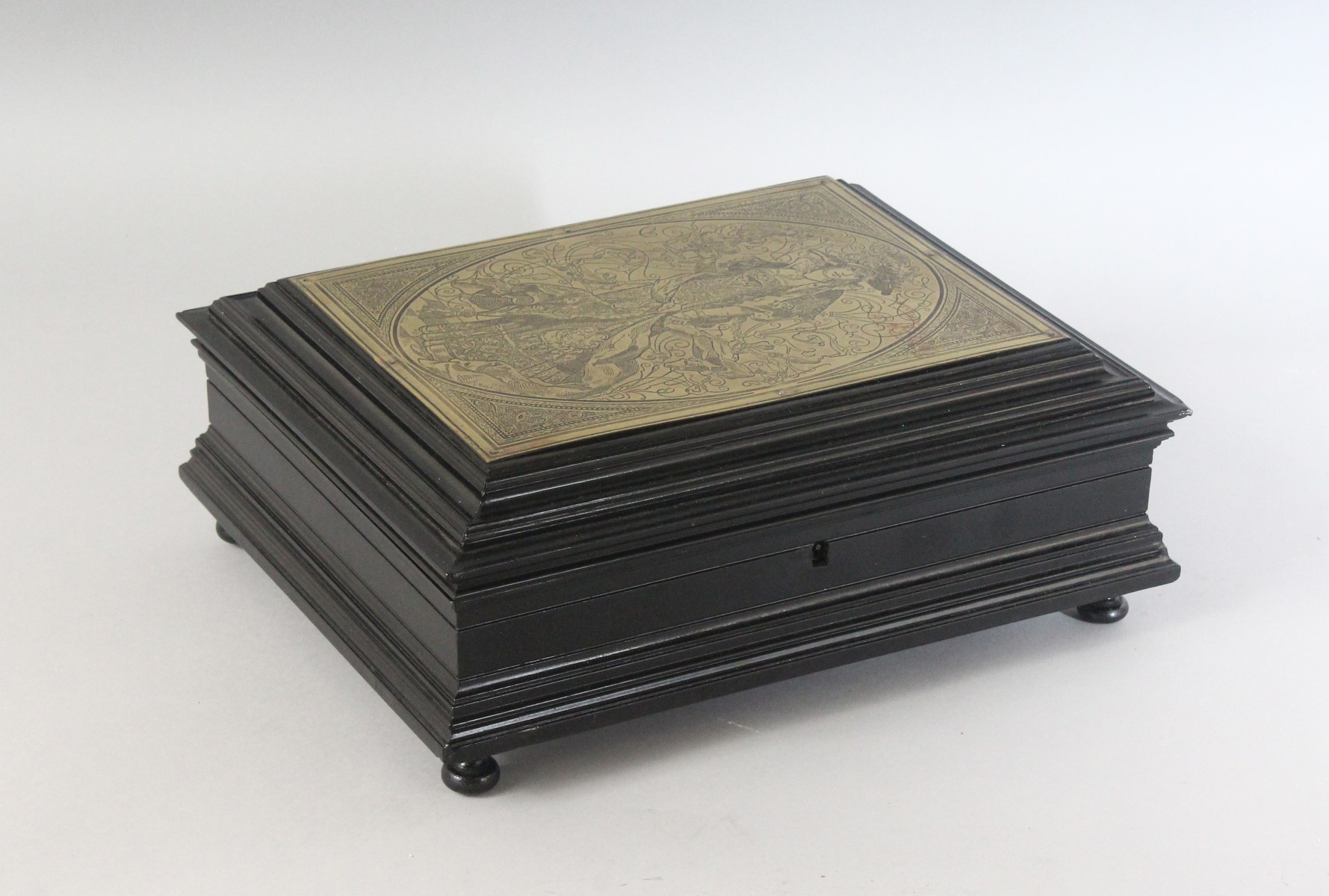 A GERMAN EBONY JEWELLERY BOX, the top with an inset brass plaque, signed C. Rohlins 1880, engraved