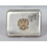 A RUSSIAN SILVER CIGARETTE CASE, with applied crest and inscription dated 1898. Stamped MAGALSKIPSYK