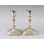 A PAIR OF QUEEN ANNE STYLE CANDLESTICKS on loaded bases. 7ins high. Birmingham 1969.