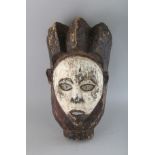A PAINTED CARVED WOOD TRIBAL MASK. 14ins.