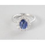A SUPERB PLATINUM CABOCHON BLUE SAPPHIRE RING, 1,94cts, surrounded by diamonds, 0.57cts.
