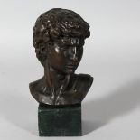 A BRONZE GRAND TOUR BUST on a marble plinth. 6ins overall.