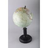 A G. THOMAS TERRESTRIAL GLOBE on a stand. 7.5ins diameter.
