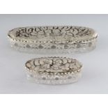 TWO SILVER ANGEL TOP GLASS PIN BOXES. 5.25ins and 3ins long. Birmingham 1914 and 1904 (2).