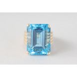 A LARGE GOLD BLUE TOPAZ RING.