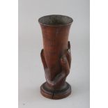 A SOUVENIR FROM PITCAIRN, carved wood hand holding a vase. 6.75ins high.