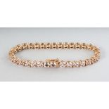 AN 18CT ROSE GOLD THIRTY-TWO STONE MORGANITE (16.65cts) LINE BRACELET.
