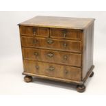 AN 18TH CENTURY WALNUT CHEST OF DRAWERS, with decoratively veneered top and drawers, boxwood