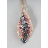 AN 18CT ROSE GOLD, AMETHYST, PERIDOT AND SWISS BLUE TOPAZ LEAF PENDANT on a chain.