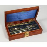 A BOX OF HOUGHTON-BUTCHER DRAWING INSTRUMENTS in a mahogany box. 8.5ins long.