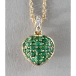 AN 18CT GOLD, EMERALD AND DIAMOND HEART SHAPED PENDANT on a chain.