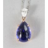 A SUPERB 18CT YELLOW AND WHITE GOLD, TANZANITE (6.04cts) AND DIAMOND (0.25cts) DROP PENDANT on an