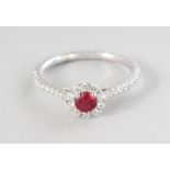 AN 18CT WHITE GOLD, ROUND SPINEL (0.32cts) AND DIAMOND (0.29cts) HALO RING.