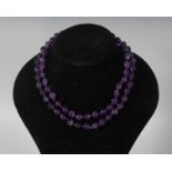 AN AMETHYST STRING NECKLACE.