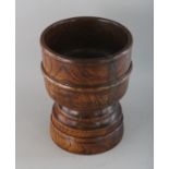 A CARVED WOOD MORTAR. 8ins high.