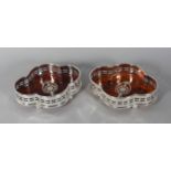 A PAIR OF SHAPED FAUX TORTOISESHELL WINE COASTERS.