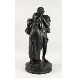 A LARGE LATE 19TH CENTURY/EARLY 20TH CENTURY BLACK PAINTED PLASTER GROUP, young lovers in an