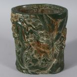 A LARGE CARVED JADE BRUSH POT, carved with Chinese figures. 6ins high.