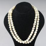 A LONG MOTHER-OF-PEARL NECKLACE.