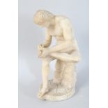 AN ITALIAN CARVED ALABASTER FIGURE, picking a thorn from his foot. 10ins high.
