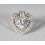 A SILVER CZ HEART SHAPED RING.