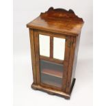A VICTORIAN ROSEWOOD MUSIC CABINET, with a mirrored and glazed single door, on a plinth base with