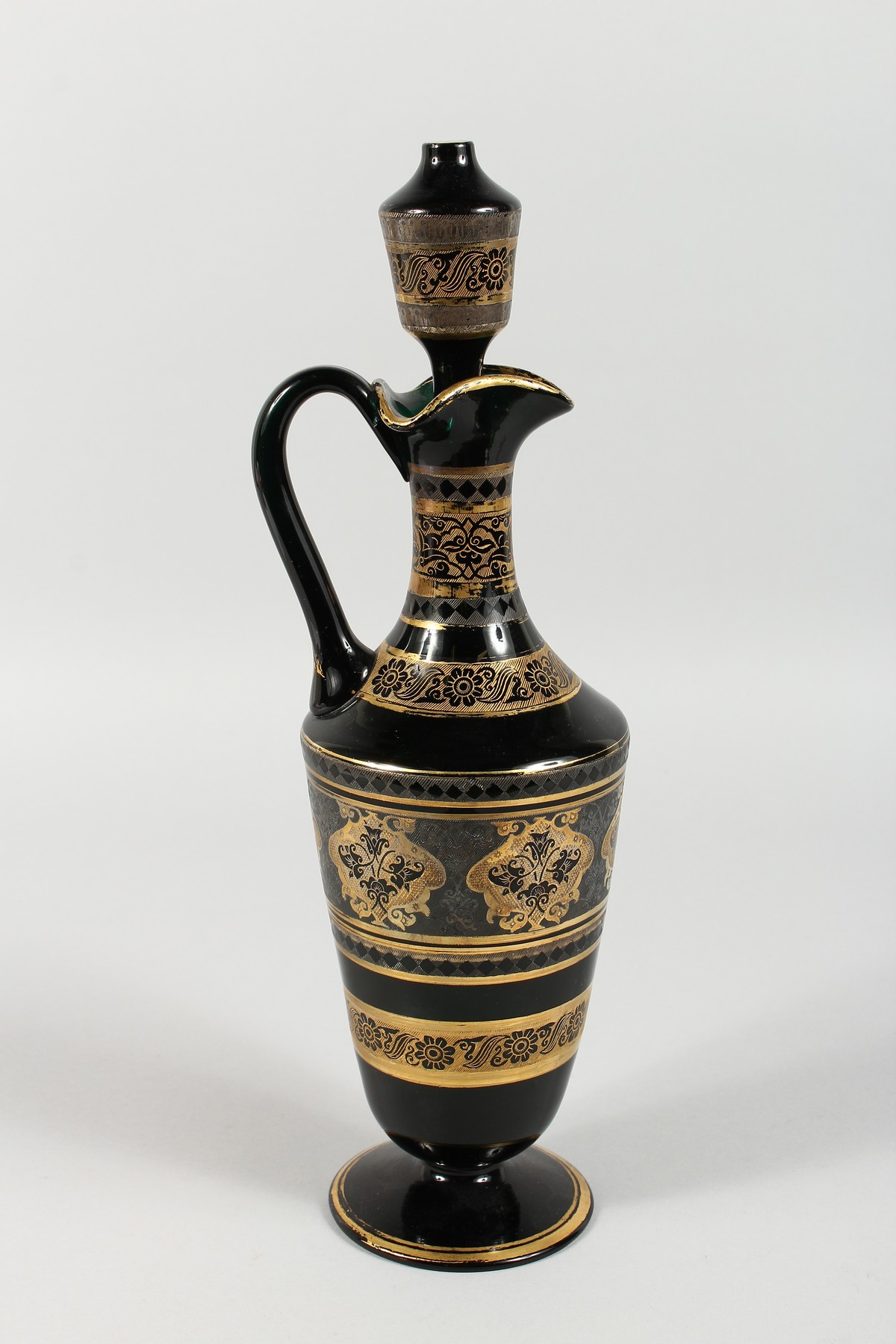 A CONTINENTAL DARK GREEN GLASS EWER AND STOPPER, with etched and gilded decoration. 14ins high. - Image 4 of 11