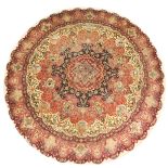 A GOOD PERSIAN CIRCULAR CARPET, with a large floral central motif, surrounded by small vignettes