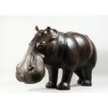 A GOOD LEATHER HIPPOPOTAMUS STOOL OF LARGE SIZE, Probably for LIBERTY & CO. 39ins long x 20ins
