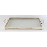 A TWO-HANDLED GLASS TEA TRAY with glass bottom. 17ins long.