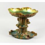AN UNUSUAL CONTINENTAL LUSTRE GLAZED POTTERY CENTREPIECE, modelled as a tree stump with moulded