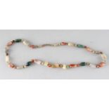 A LONG HARDSTONE NECKLACE.