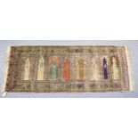 AN UNUSUAL PERSIAN PRAYER RUG, the central panel with eight arches and hanging lamps, within a