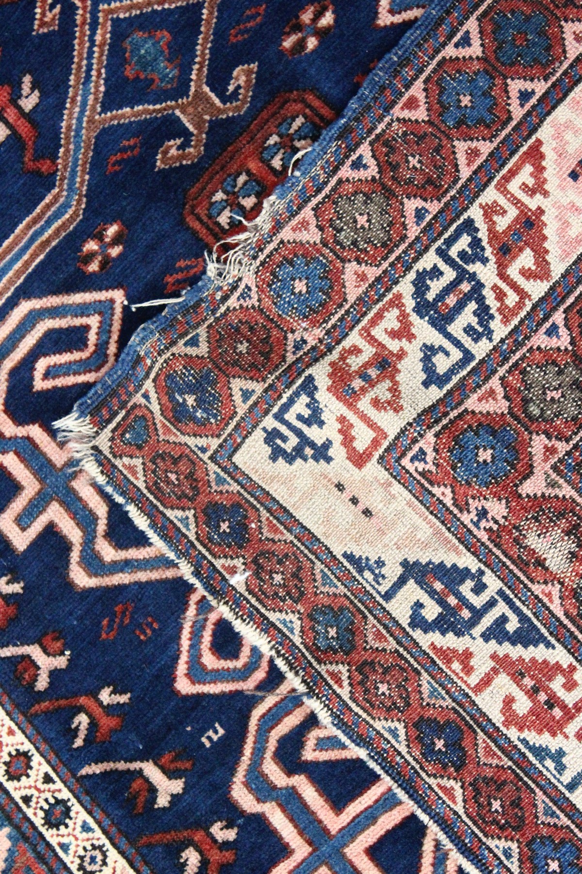 A CAUCASIAN RUG, mid 20th century, dark blue ground with stylised decoration within a five row - Image 5 of 5